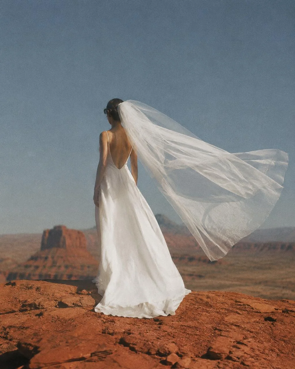 Bride's veil caught in desert wind