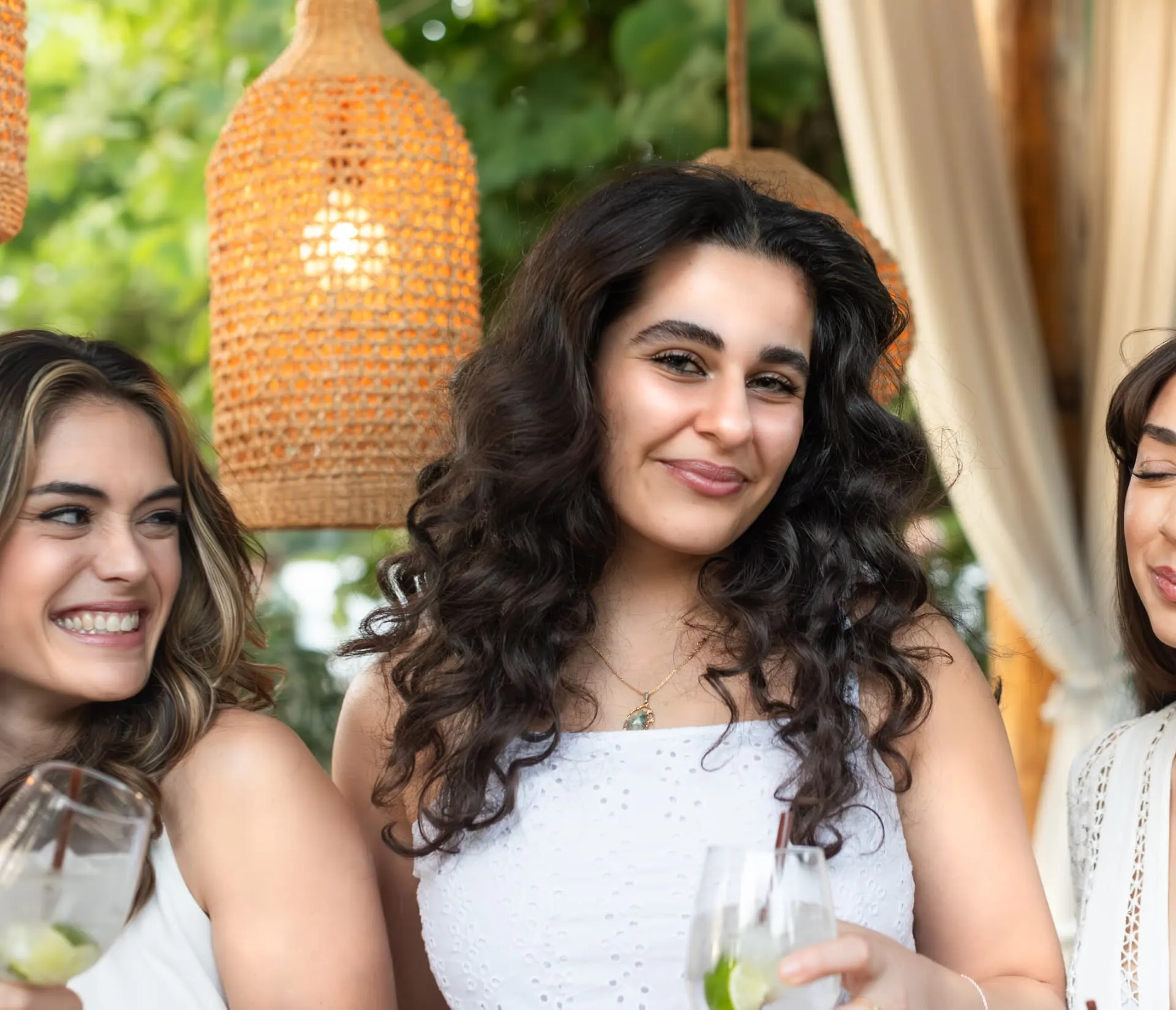 Close portrait of a bachelorette guest smiling under warm lantern light